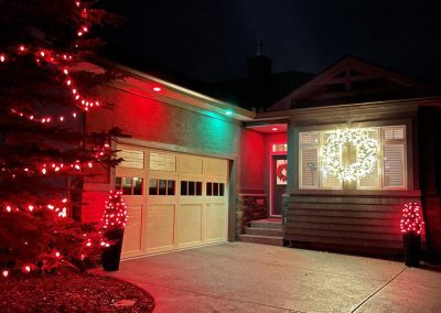 image of Installed colour changing programmable LED pot lights set to red and green in the soffit of a home